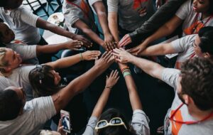 people putting their hands in a circle to show community